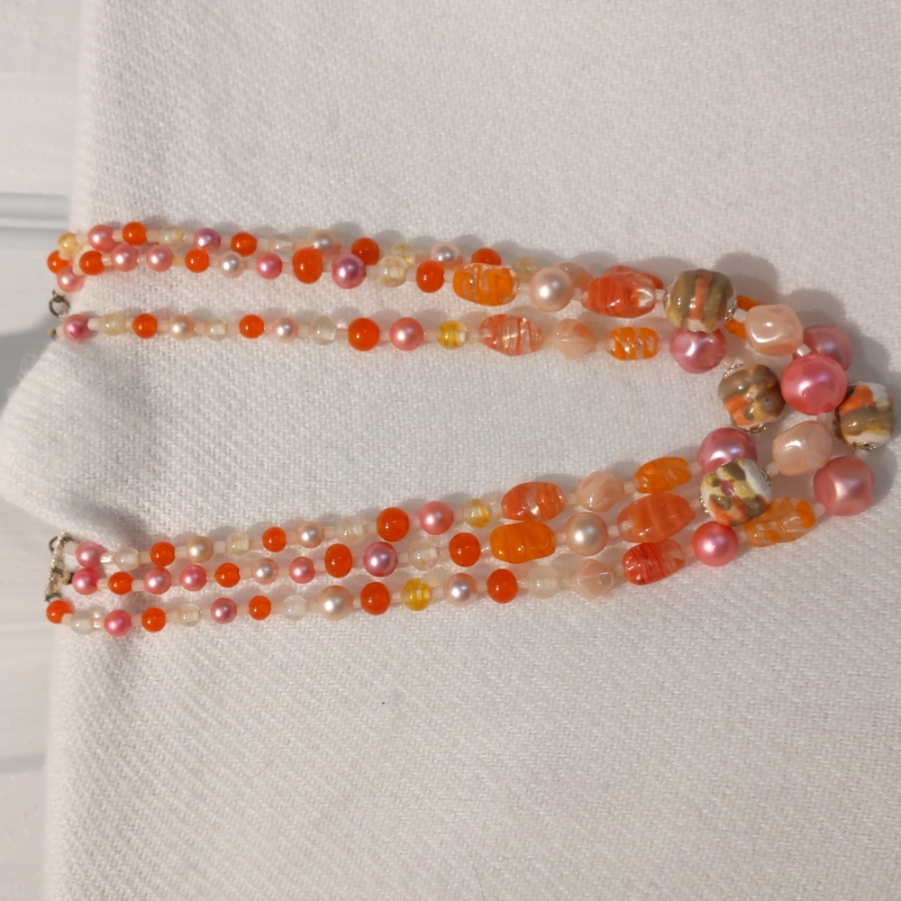 Vintage three strand glass necklace in pink orange and yellow.
